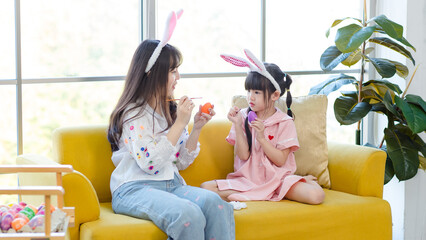 Asian cute little children girl wearing funny bunny ears headbands and young happy mother smile...