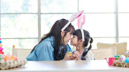 Asian cute little children girl wearing funny bunny ears headbands and young happy mother smile...