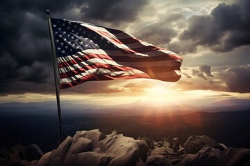 US flag in top of a hill against sun rays