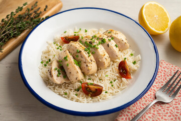 Chicken cooked with lemon and thyme over rice.