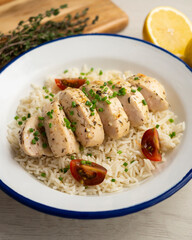 Chicken cooked with lemon and thyme over rice.