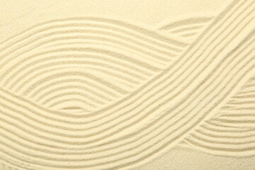 Fototapeta na wymiar Zen rock garden. Wave pattern on beige sand, top view