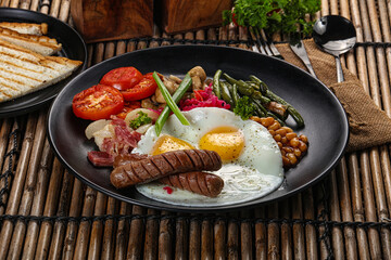 Traditional Engrlish breakfast with egg  and sausages