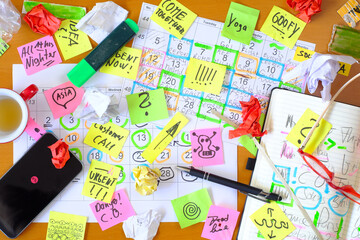 Calendars with business appointments and adhesive notes on cluttered desk. Business concept,beat...