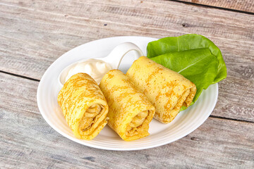 Stuffed pancakes with cream sauce