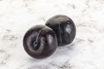 Two ripe sweet black plums