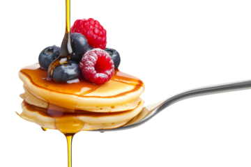 A fork with a stack of mini pancakes drizzled with syrup and topped with berries creates a delicious breakfast close-up.