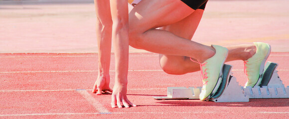Cropped image of a sprinter getting ready to start at the stadium