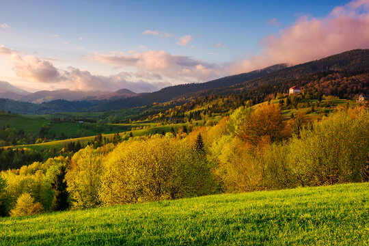 carpathian countryside scenery with forested hills in evening light. mountainous rural landscape of transcarpathia in spring