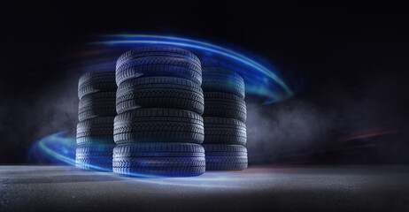 car tire stack at repairing service on black background. Transportation and automotive maintenance...