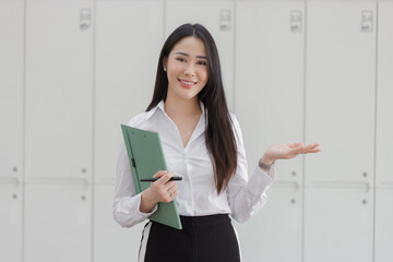 Happy asian young businesswoman holding documents folders in office working space, Asian female...
