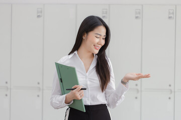 Happy asian young businesswoman holding documents folders in office working space, Asian female...