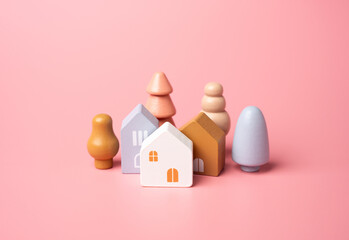 Houses and tree figures on a pink background. Affordable housing. Buying a nice house. Garden ,...
