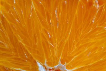 Close up of sliced ripe orange, macro. Yellow fresh orange surface background or texture