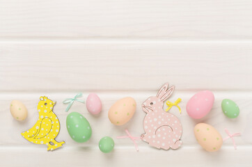 Easter eggs and decoration on wooden background, top view