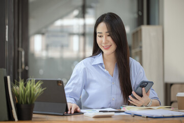 Happy asian young businesswoman excited with smartphone at workplace, Excited happy Asian woman.
