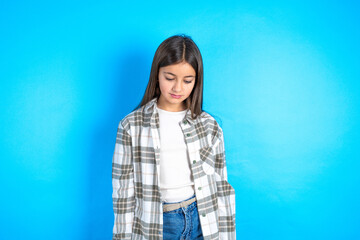 Young beautiful teen girl wearing check shirt looking sleepy and tired, exhausted for fatigue and hangover, lazy eyes in the morning.