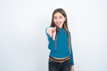 Young beautiful teen girl wearing blue T-shirt Pointing with finger surprised ahead, open mouth amazed expression, something on the front.