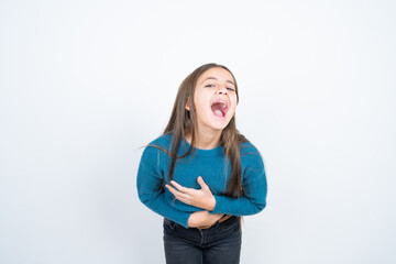 Young beautiful teen girl wearing blue T-shirt smiling and laughing hard out loud because funny...