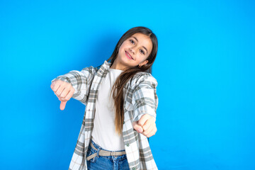 Young beautiful teen girl wearing check shirt imagine steering wheel helm rudder passing driving exam good mood fast speed