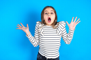 Surprised terrified Young beautiful teen girl wearing striped T-shirt  Gestures with uncertainty,...