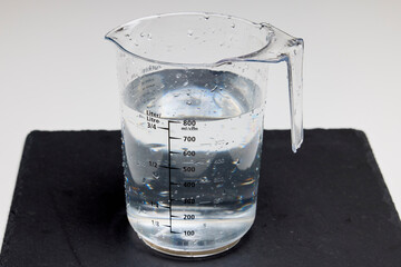 a container with graduated water for measurement