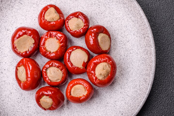 Red bell peppers stuffed with cheese or meat with salt, spices and herbs