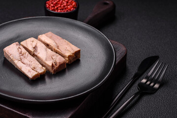 Delicious canned dietary tuna meat with salt, spices and oil