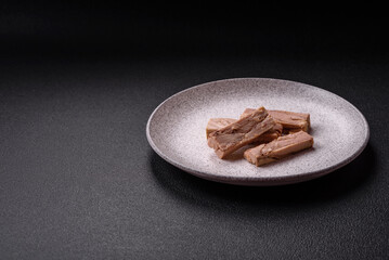 Delicious canned dietary tuna meat with salt, spices and oil