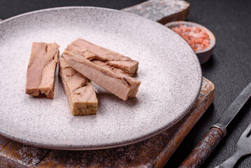 Delicious canned dietary tuna meat with salt, spices and oil