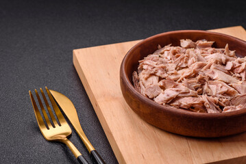 Delicious canned dietary tuna meat with salt, spices and oil