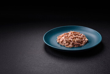 Delicious canned dietary tuna meat with salt, spices and oil