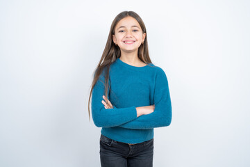 Dreamy rest relaxed beautiful kid girl wearing blue sweater crossing arms,