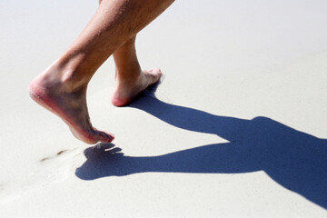 Men walking on sand beach