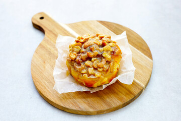 Butterscotch bread with raisin filling, topped with caramel-coated cashew nuts.