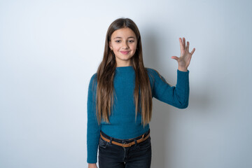 beautiful kid girl wearing blue sweater showing and pointing up with fingers number five while smiling confident and happy.