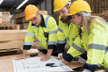 Warehouse and factory concept. Group of male and female warehouse workers working and discussing...