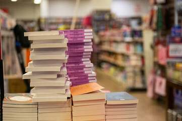 Close-up view of stacked books in a bookshop.