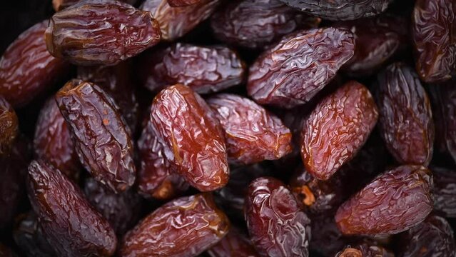 Date fruits. Dates fruit close up design background. Heap of Medjool dates close up, macro shot. Dried fruits, healthy vegan food backdrop rotating