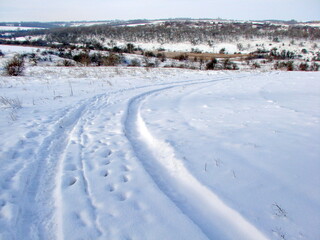 A difficult descent along an almost untrodden road on a snow-covered hillside to the thickets of a forest stream.