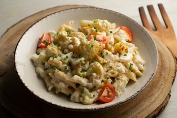 Macaroni cooked with cream, cheese and baked cauliflower.