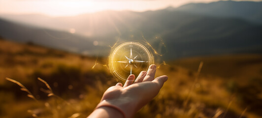 Orientation outdoors and finding the way concept with hand holding virtual compass in middle of nature at sunset