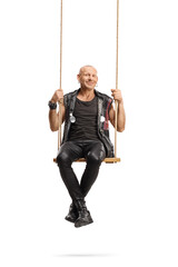 Punk sitting on a swing and smiling