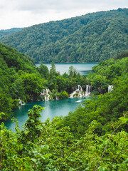 Fototapeta na wymiar Scenic view of lush green forest and a serene river in Plitvice Lakes National Park, Croatia