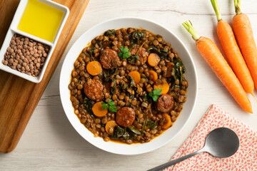 Lentil stew with chorizo and carrot. Traditional Spanish recipe.
