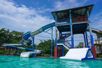 The swimming pool is equipped with various water rides