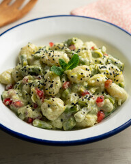 Gnocchi with yogurt sauce and asparagus. Italian potato gnocchi with traditional sauce.