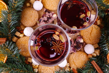 Festive composition on the theme of Christmas with mulled wine, a wreath of coniferous branches and...