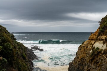 waves breaking on rocks in on the coast by the sea in tasmania australia in summer