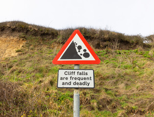 Sign warning people of potential cliff falls on Dunwich Beach, Suffolk. UK